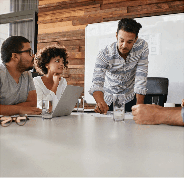 A group of people sitting around a table.